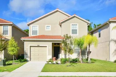 a house with a garage in a residential neighborhood at Very Private Pool & Spa, Spacious, Wifi - 3507Pp in Kissimmee