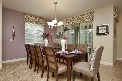 a dining room with a table and chairs at House Wpool And Jacuzzi In Paradise Palms-3151Pp in Kissimmee