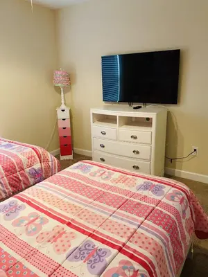 a bedroom with a bed and a flat screen tv at House Wpool And Jacuzzi In Paradise Palms-3151Pp in Kissimmee