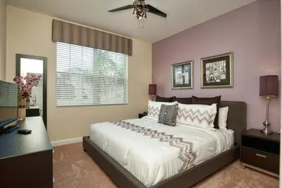 a bedroom with a large bed and a window at House Wpool And Jacuzzi In Paradise Palms-3151Pp in Kissimmee
