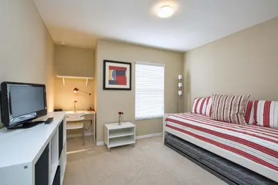 a room with a couch and a desk with a computer at Paradise Palms-4 Bed Townhome W-Splashpool-3035Pp in Kissimmee