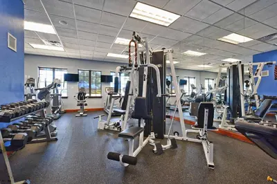 a gym with lots of tread machines and weights at Paradise Palms-4 Bed Townhome W-Splashpool-3035Pp in Kissimmee
