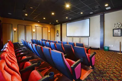 a conference room with blue and red chairs and a screen at Paradise Palms-4 Bed Townhome W-Splashpool-3035Pp in Kissimmee