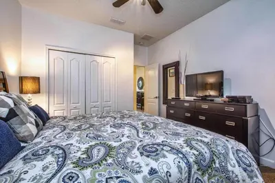 a bedroom with a large bed and a television at Conservation View, Resort, Pool Home-3116Pp in Kissimmee
