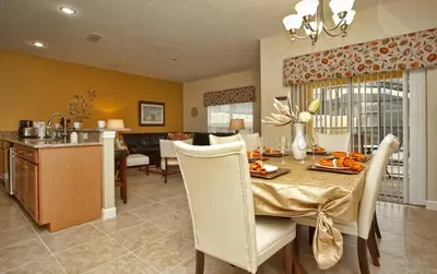 a dining room and kitchen with a table and chairs at Dog Friendly Townhome W Splashpool-3202Pp in Kissimmee