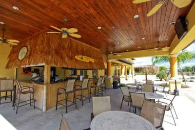 a restaurant with tables and chairs and a bar at Dog Friendly Townhome W Splashpool-3202Pp in Kissimmee