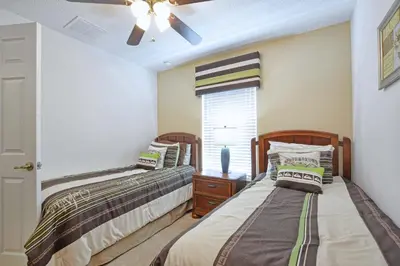 a bedroom with two beds and a window at Encantada -4 Bedroom Townhome W- Splashpool-2651En in Kissimmee