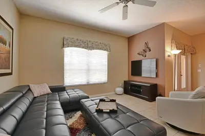 a living room with a leather couch and a television at Close To Clubhouse, Bbq, Wifi-3001Ppr in Kissimmee