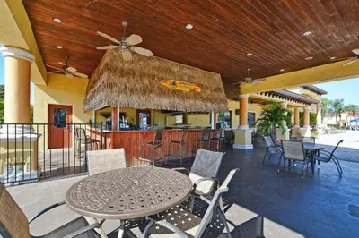 a patio with a table and chairs and a bar at Close To Clubhouse, Bbq, Wifi-3001Ppr in Kissimmee