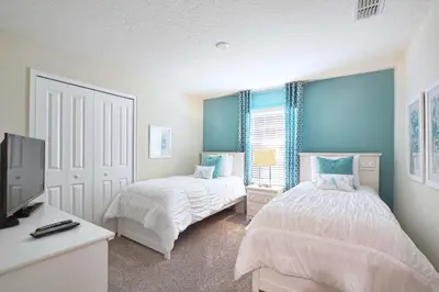 a bedroom with two beds and a flat screen tv at Lakefront Retreat Wpvt Splashpool-1617St in Kissimmee