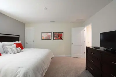 a bedroom with a bed and a flat screen tv at Lakefront Retreat Wpvt Splashpool-1617St in Kissimmee