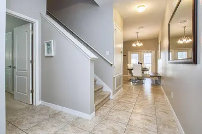 a hallway of a home with a staircase and a dining room at Bright & Cheery Decor, Townhome Wspashpool-3015Pp in Kissimmee