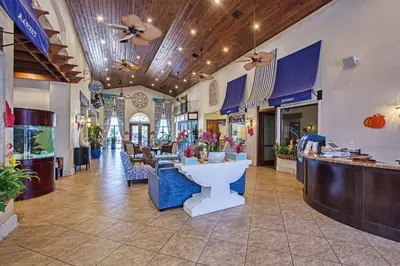 a store lobby with a counter with flowers in it at Paradise Palms-4 Bed Townhouse Wsplashpool3622Ppr in Kissimmee