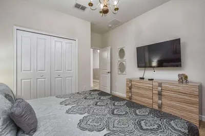 a bedroom with a bed and a flat screen tv at Across From Clubhouse, Private PoolSpa-1651Str in Kissimmee