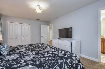 a bedroom with a bed and a flat screen tv at Across From Clubhouse, Private PoolSpa-1651Str in Kissimmee