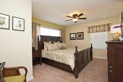 a bedroom with a bed with a ceiling fan at Beautiful Waterfront Townhome Wsplashpool-3024 in Kissimmee