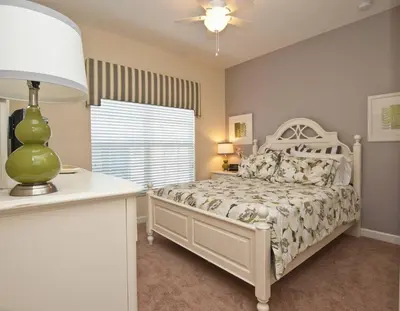 a bedroom with a white bed and a window at Beautiful Waterfront Townhome Wsplashpool-3024 in Kissimmee