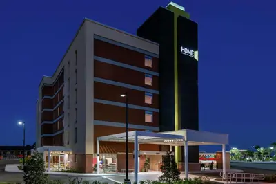 a hotel with a sign on the side of a building at Home2 Suites By Hilton Orlando Near Universal in Orlando