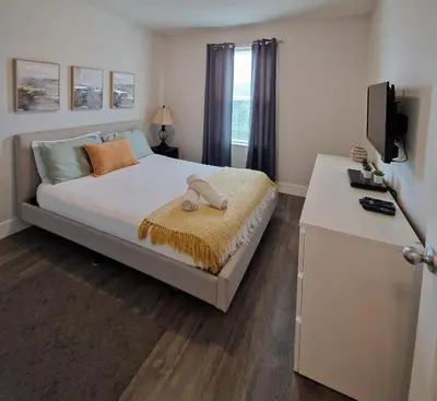 a bedroom with a bed and a television in it at Home Away From Home in Kissimmee
