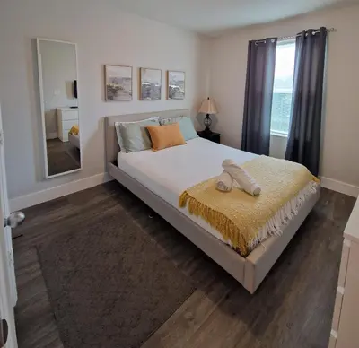 a bedroom with a large bed and a large mirror at Home Away From Home in Kissimmee