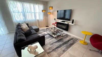 a living room with a couch and a flat screen tv at Home Away From Home in Kissimmee