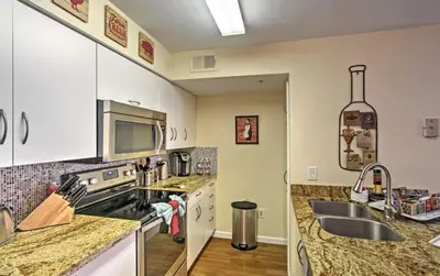a kitchen with a sink and a stove top oven at Disney Adjacent in Kissimmee