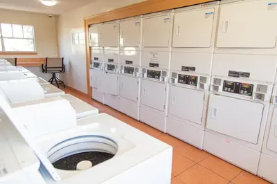 a row of white washing machines in a room at Disney Adjacent in Kissimmee