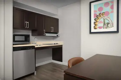 a kitchen with a counter top and a microwave at Homewood Suites by Hilton Orlando Airport in Orlando