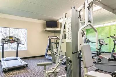 a gym with treadmills and ellipticals in a building at La Quinta by Wyndham Orlando Airport - On Property Food Trucks & Free Airport Shuttle! in Orlando