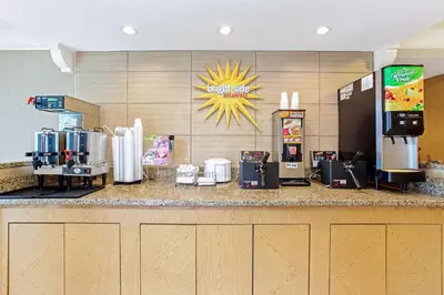 a counter in a fast food restaurant with a drink station at La Quinta Inn by Wyndham Orlando Airport West in Orlando