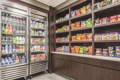 a grocery store aisle with shelves of food and drinks at La Quinta by Wyndham Orlando Lake Mary in Lake Mary