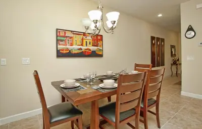 a dining room with a table and chairs at South Facing Pool Wsplashpool- 3080Pp in Kissimmee