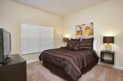 a bedroom with a bed and a television in it at South Facing Pool Wsplashpool- 3080Pp in Kissimmee