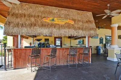 a bar with a surfboard on top of it at South Facing Pool Wsplashpool- 3080Pp in Kissimmee