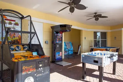 a room with a video game system and a table at Gorgeous Apartment in Orlando at Vista Cay Resort in Orlando
