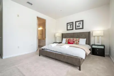 a bedroom with a large bed and two lamps at Wonderful Apt Convention Center VistaCay VC50253 in Orlando