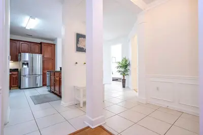 a kitchen with white walls and a white tile floor at Wonderful Apt Convention Center VistaCay VC50253 in Orlando