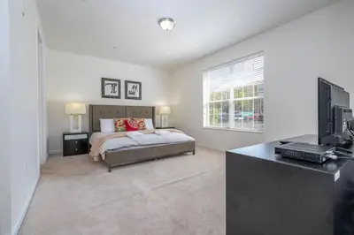 a bedroom with a bed and a flat screen tv at Wonderful Apt Convention Center VistaCay VC50253 in Orlando