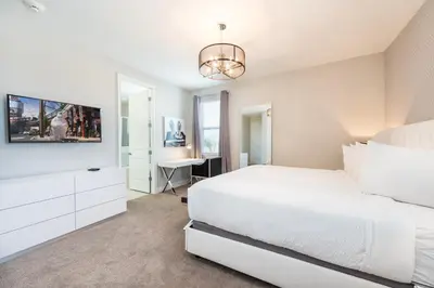 a white bedroom with a bed and a desk at Gorgeous Home With Private Pool, Themed Rooms Near Disney With Waterpark & Resort Access At Encore Resort - 7687Ff in Kissimmee