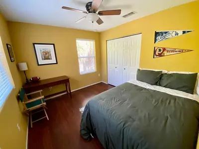 a bedroom with a bed and a ceiling fan at Beautiful Hollywood style home next to Disney in Kissimmee