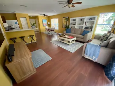 a living room with a couch and a table at Beautiful Hollywood style home next to Disney in Kissimmee