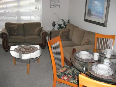 a living room with a couch and a table and chairs at Venetian Bay Villa 4 Bedroom Townhouse - Near Disney in Kissimmee