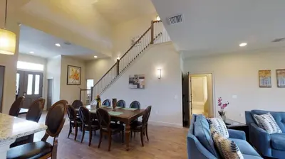 a dining room and living room with a table and chairs at 6 Bed, 4 Bath perfect for group or large family in Oviedo