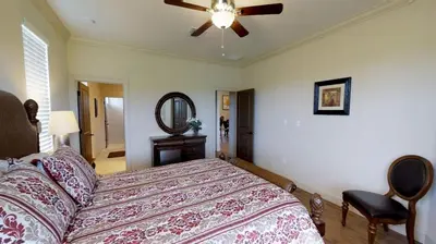 a bedroom with a bed and a ceiling fan at 6 Bed, 4 Bath perfect for group or large family in Oviedo