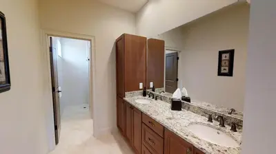 a bathroom with two sinks and a large mirror at 6 Bed, 4 Bath perfect for group or large family in Oviedo