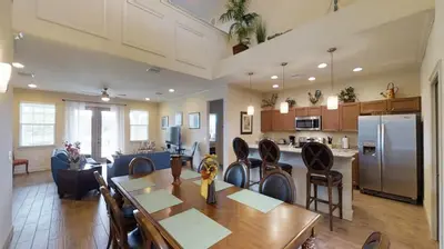 a kitchen and living room with a table and chairs at 6 Bed, 4 Bath perfect for group or large family in Oviedo