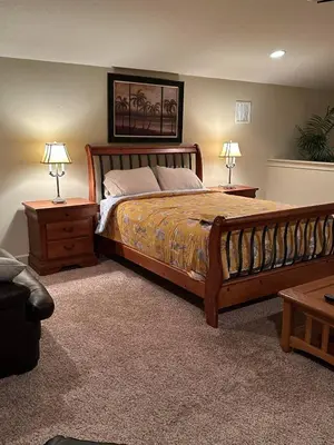 a bedroom with a large bed with two tables and two lamps at 6 Bed, 4 Bath perfect for group or large family in Oviedo