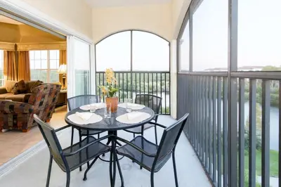 a screened in porch with a table and chairs at WQR Private Rentals No Resort Pool Access in Orlando