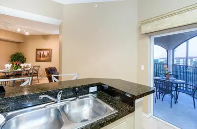 a kitchen with a sink and a dining room at WQR Private Rentals No Resort Pool Access in Orlando