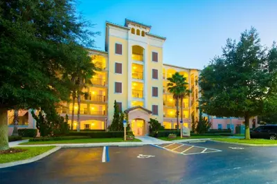 a large building with a parking lot in front of it at WQR Private Rentals No Resort Pool Access in Orlando